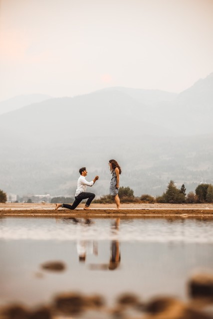 Young couple hold hands on beach