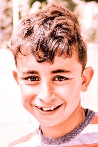 Portrait photo of Evan as a young boy smiling